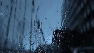 Raindrops fall on the window