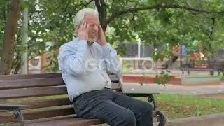 Tired Senior Old Man Sitting Outdoor with Headache Video Footage Stock