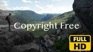 NO COPYRIGHT VIDEO. Teenage Boy Overlooks and Photographs Vast Wyoming landscape. Copyright Free.