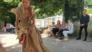 A model takes off her shoes as she walks on the runway