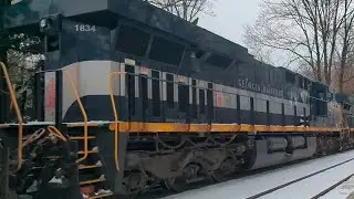 CSX train C754 with GEORGIA RAILROAD HERITAGE UNIT 1834 passes Garrett Park, MD on a cold snowy day.