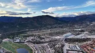 Drone captures lush grounds at dawn, Resort landscape with water features and winding roads at