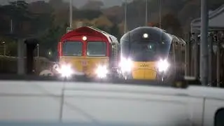 Class 66 and class 80X IET train approaches exeter st davids, both with tones