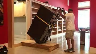 Installing a safe in a hidden room behind the bookcase.