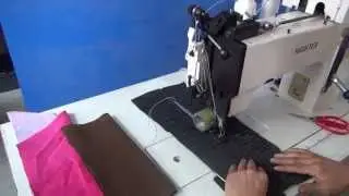 Ornamental stitching machine for sewing fabrics with braided thread