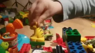 Huginn playing with LEGO house and Sully from Monsters INC puppet