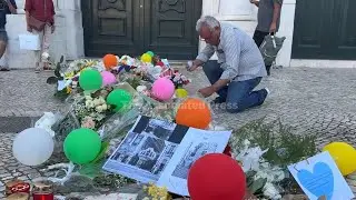 Locals and tourists place tributes near site of deadly streetcar crash in Lisbon