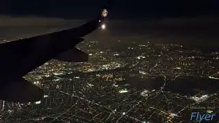 Night landing over Paris, France: view of the Tour Eiffel and the Seine river while landing at CDG
