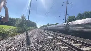 Amtrak 609 passing field ACS-64 645 leading and metroliner 9649 and ACS-64 628 trailing