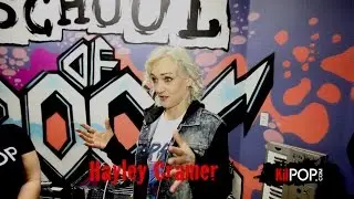 Hayley Cramer drummer of Pop Evil giving drum lessons at School of Rock.