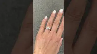 Oval engagement ring with 3 round diamonds on each side