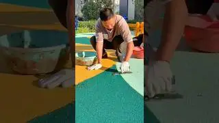 Applying and Smoothing Colorful Rubber Flooring for a Safe and Durable Playground Surface #shorts
