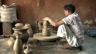 Potter at work at his pottery wheel