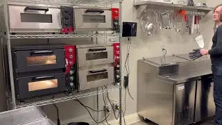 Cast Iron Pizza owner Jacob Black takes a pepperoni pizza out of the oven