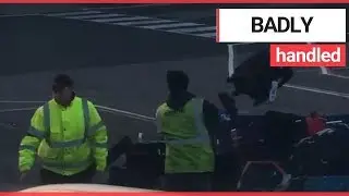 Man films baggage handlers throwing luggage onto a cart | SWNS TV
