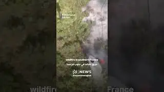 Helicopter dropping water over wildfire in southern France