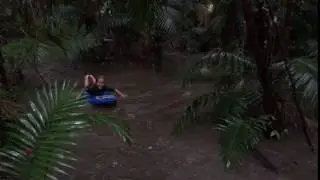 Mikky floating down creek on Boogie board