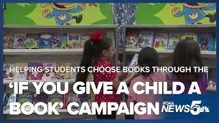 Volunteers at West Elementary help students choose their books at the book fair for free