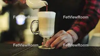 The barman is making cappuccino.