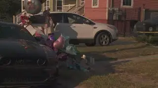 Family and community members mourn the loss of the three children killed in deadly house fire