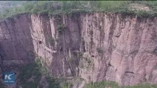 Most dangerous road! Villagers carve out tunnel in steep rock cliff