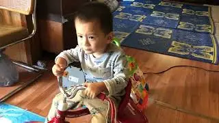 Samuel eating small apples.