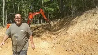 Moving tree's and dirt with the Kubota 33-4 / John Deere 1025r