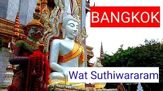 Walk to see Wat Suthiwararam on Charoen Krung Road.