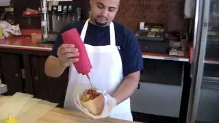 Jan Gallant Of Magic Eye Communications Samples The Italian Hotdogs At Dickie Dees In Newark NJ