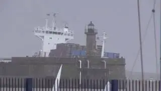 Container ship entering Leixoes harbour  in a storm (north of Portugal)