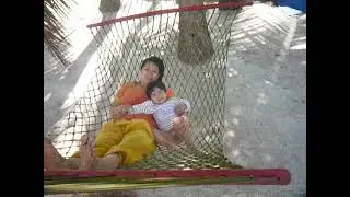 MOtHER and baby relaxing on a swing