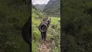 Line workers of the China Power Grid are laying electric wires in the mountains
