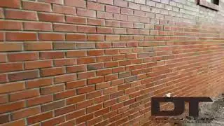 Graffiti Remover Taginator takes spray paint vandalism off a brick wall.