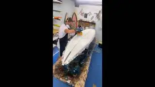 SURFBOARD GLASSING. GLASSING BOTTOM 8'0 HANDSHAPED SURFBOARD.