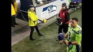 Seahawks Russell Wilson giving gear to kids after games.