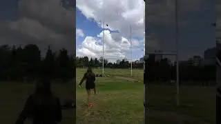 Girl Kicks Rugby Ball Above Crossbar of Goal Posts - 1025026
