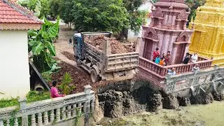 Nice bulldozer pushing soil and filling land with dump trucks 