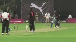 Bolt takes part in a cricket match against Yuvraj Singh
