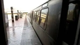 Orange Line train departs West Falls Church-VT/UVA station on center track