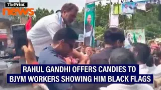 LoP Lok Sabha Rahul Gandhi offers candies to protesting BJYM workers with black flags