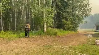 Tanana Chiefs Crew spray water near structures on the Pogo Mine Road Fire (#191) - August 6, 2023