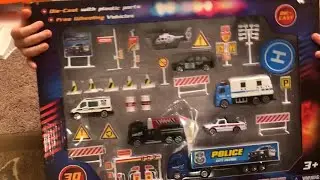 DIE-CAST EMERGENCY PLAYSET, Sean playing with police cars