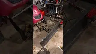 Toro lawn mower with plow on front.