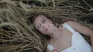 Dreamy Girl Lying on Golden Ripe Wheat Field | Stock Footage - Envato elements