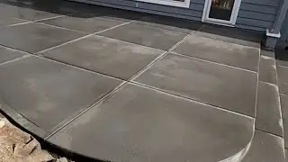 Color concrete patio with picture frame checkerboard pattern.