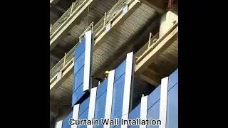 How are the glass curtain walls of skyscrapers installed?