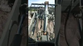 Root raking with a Doosan DL220 front end loader