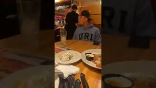 Person Dressed As Batman Walks Through Restaurant A