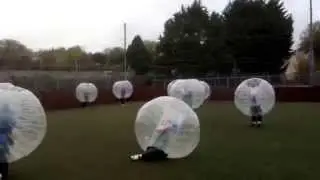 Tough man gets sent flying by rookie in zorb football.priceless