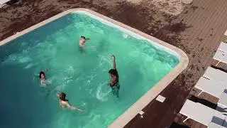 Aerial Shot of Friends Jumping in Pool | DRONE SHOT | STOCK VIDEO